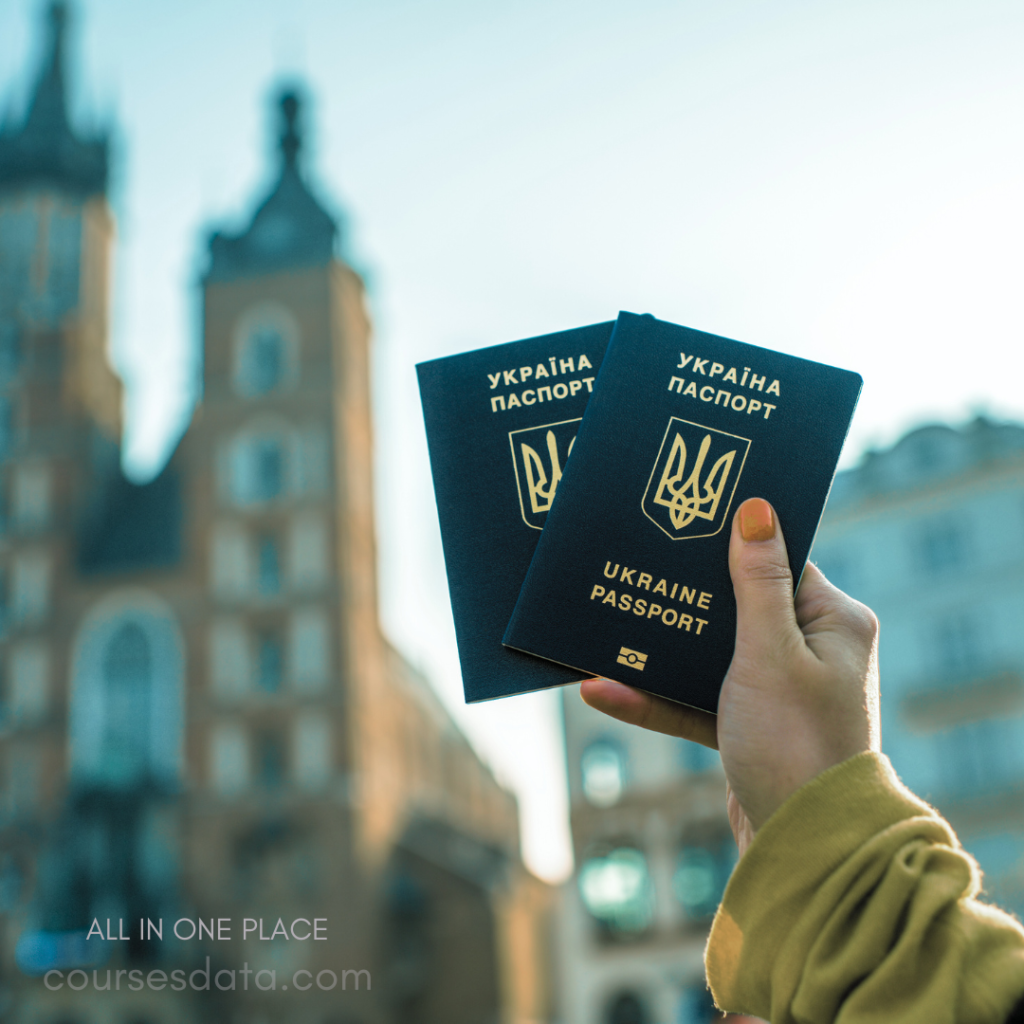 Person holding Ukraine passports. Background includes historical buildings. Bright outdoor setting, soft focus. Main subject emphasizes travel documentation.