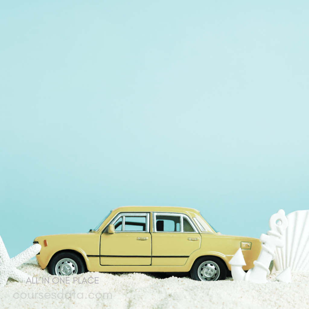 Yellow toy car in sand. Starfish beside the car. Seashells in the background. Blue backdrop overhead. Beach-themed scene elements.