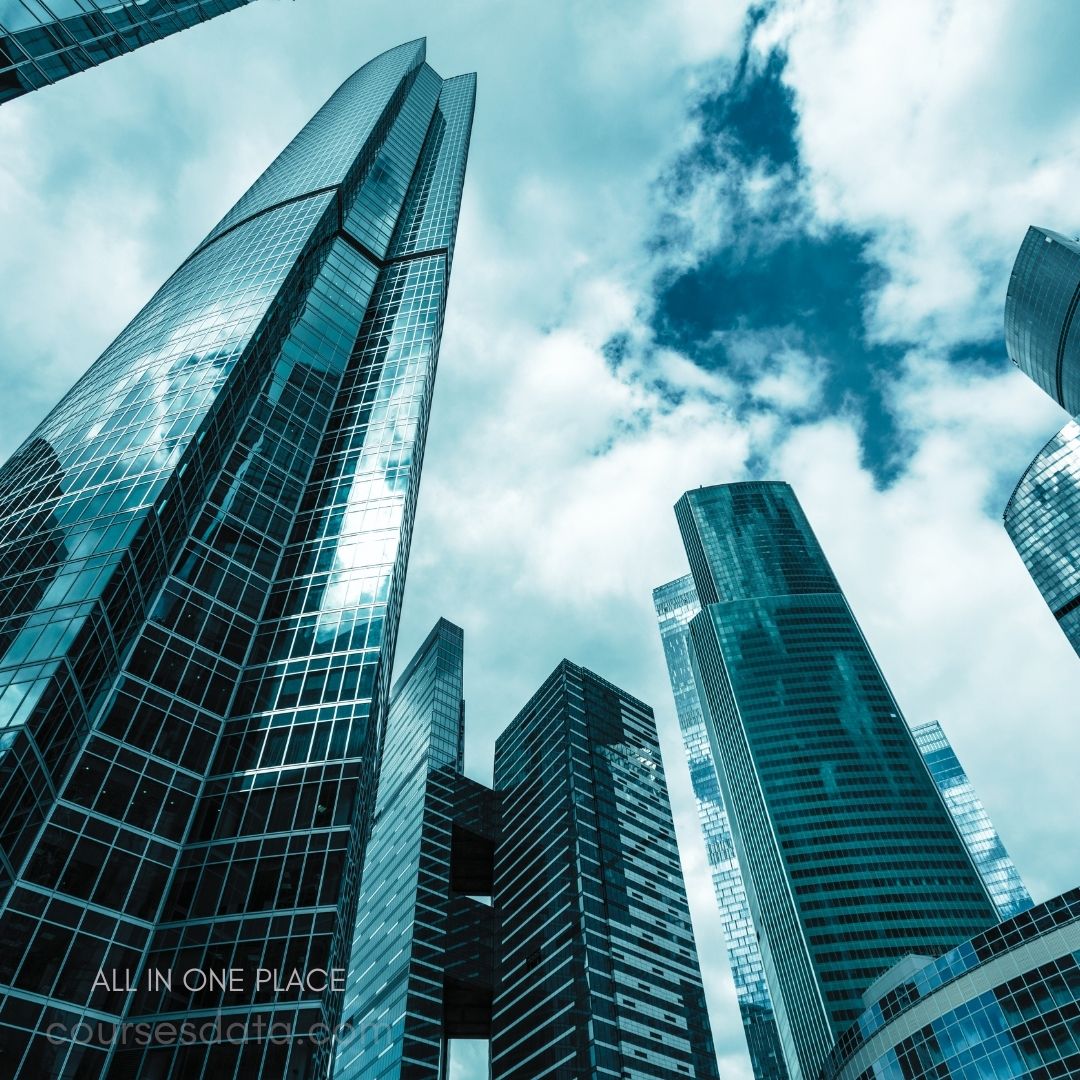 Tall glass skyscrapers, dramatic perspective, cloudy sky.