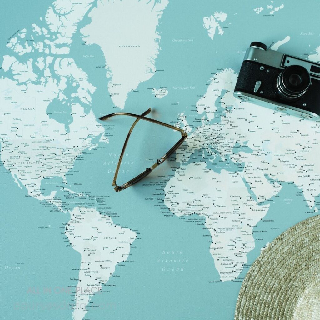 World map background, camera, sunglasses.