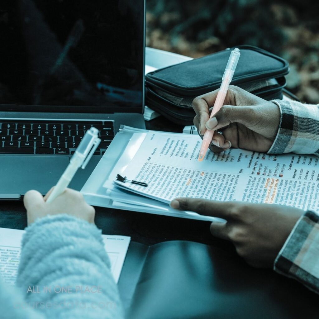 Student studying with documents. Laptop on table, focus area. Hands holding pens and papers. Highlighted text for review. Soft, natural lighting ambiance.