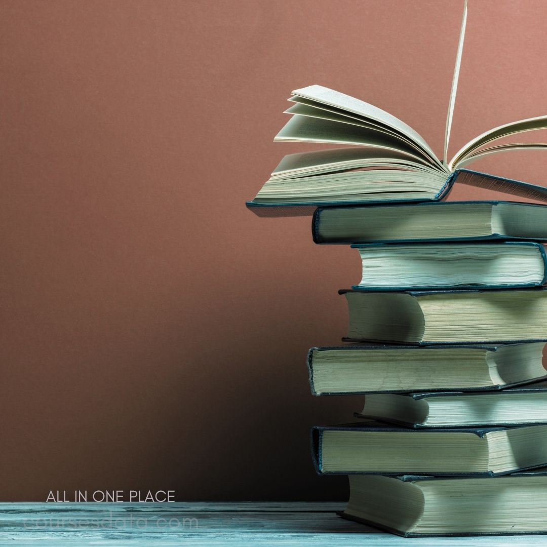 Stack of open books, brown background.