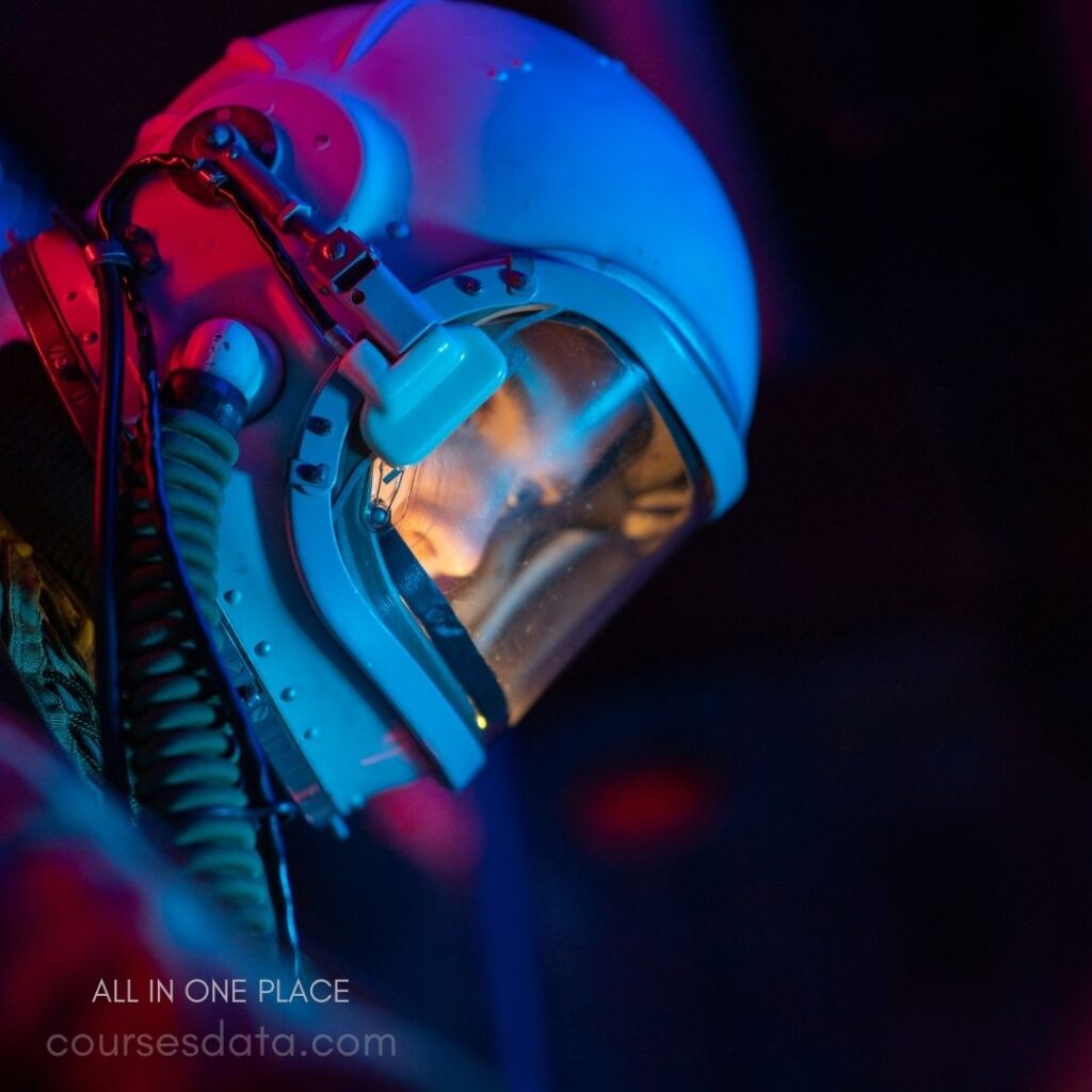 Astronaut helmet in vibrant lighting. Close-up of visor reflection. Bright blue and purple hues. Intricate headset and cables visible. Focus on helmet details.