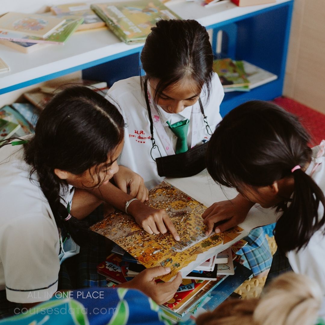 Students examining colorful book illustrations.