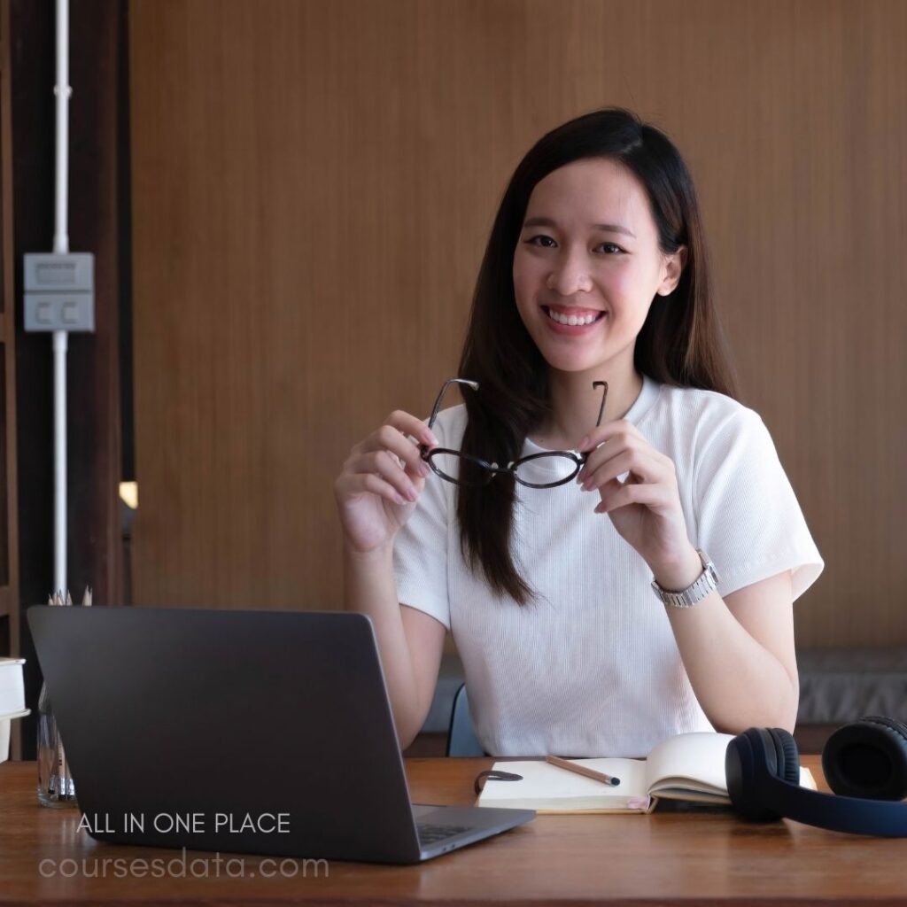 Smiling woman holding glasses.