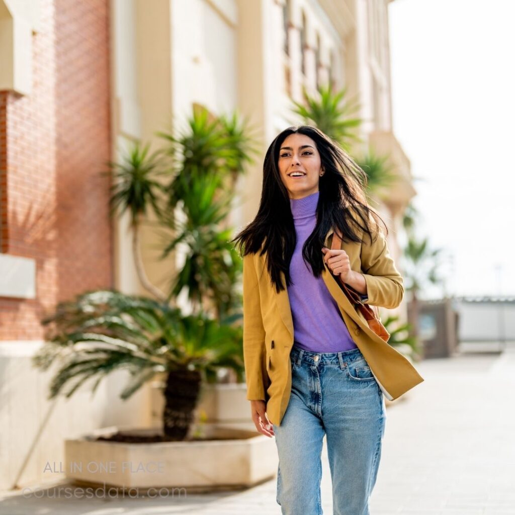 Young woman walking confidently outdoors.