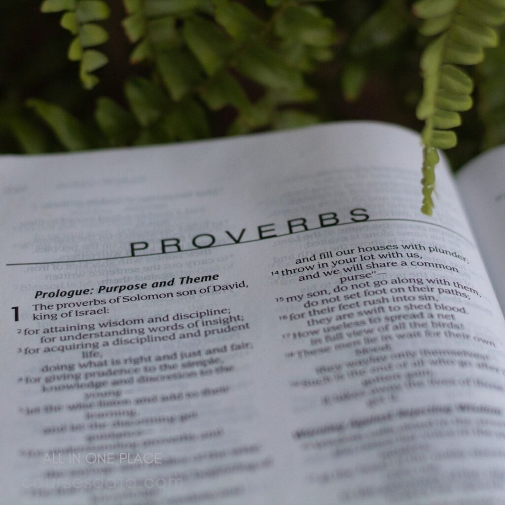 Open book with Proverbs scripture.