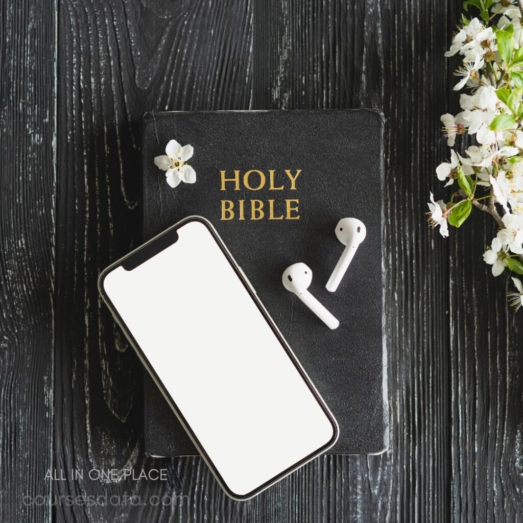 Smartphone beside a Bible and AirPods.