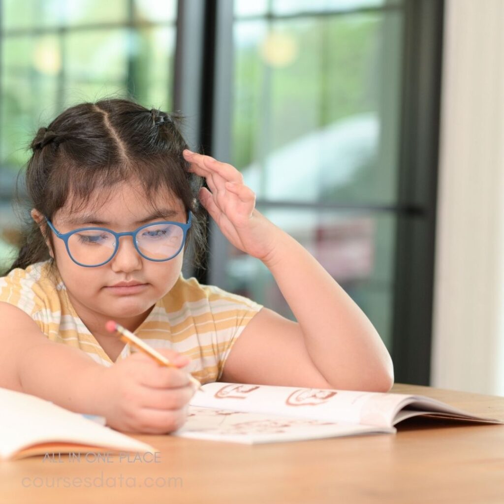 Girl studying with pencil, thoughtful.