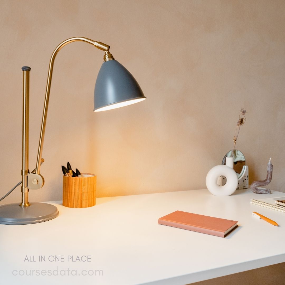 Desk with lamp and notebook.