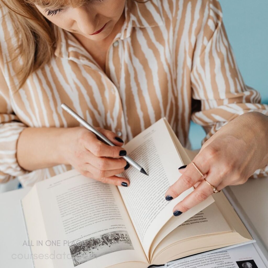 Woman reading and annotating book.