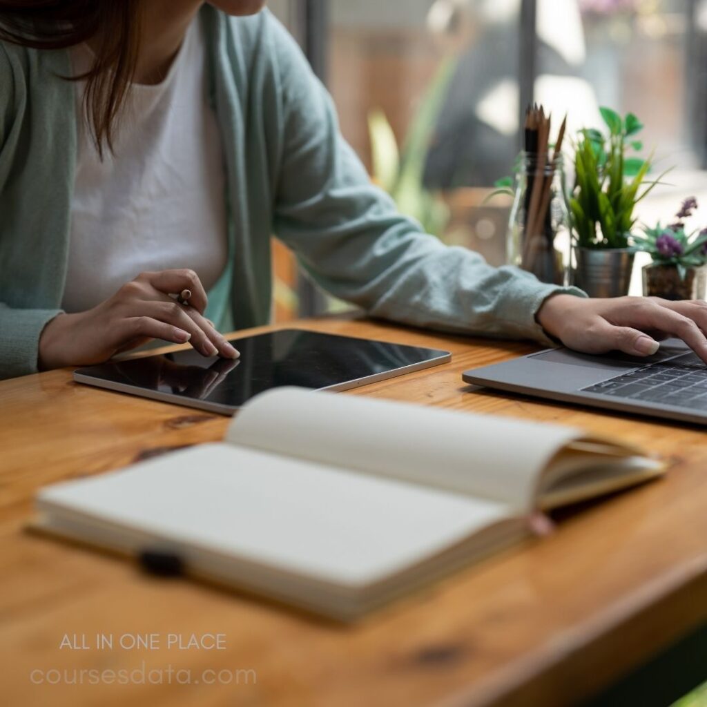 Woman using tablet and laptop.