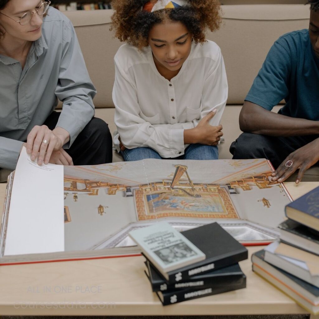 Students examining a large book.