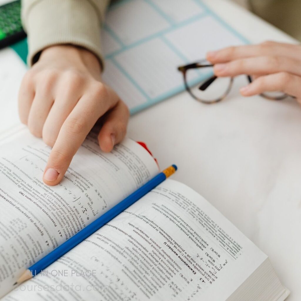 Person studying from an open textbook.