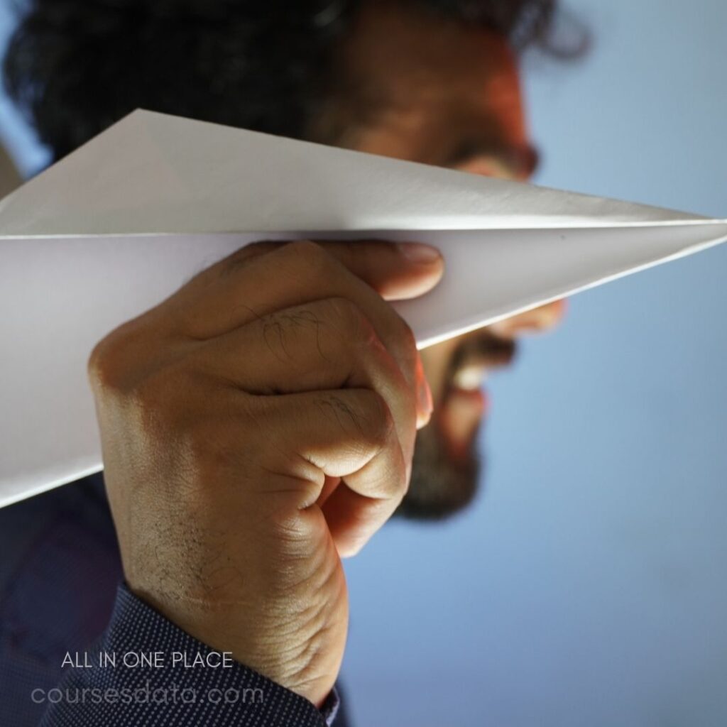 Person holding paper airplane.