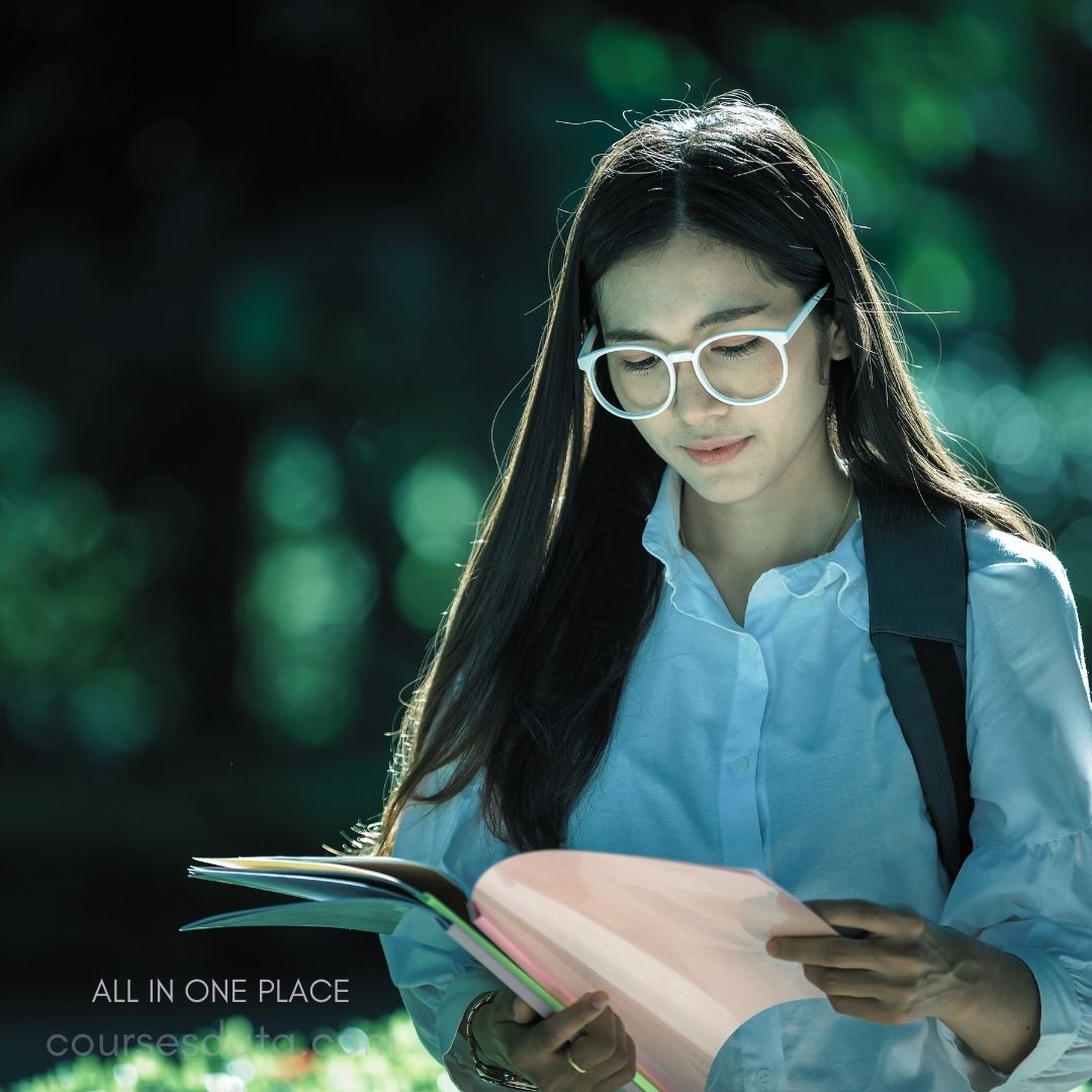 Young woman reading colorful folder.