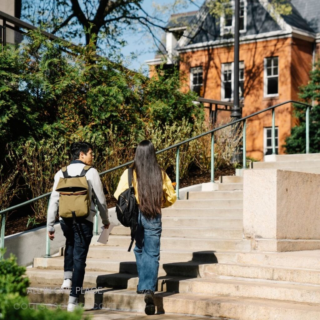 Two students walking up stairs.