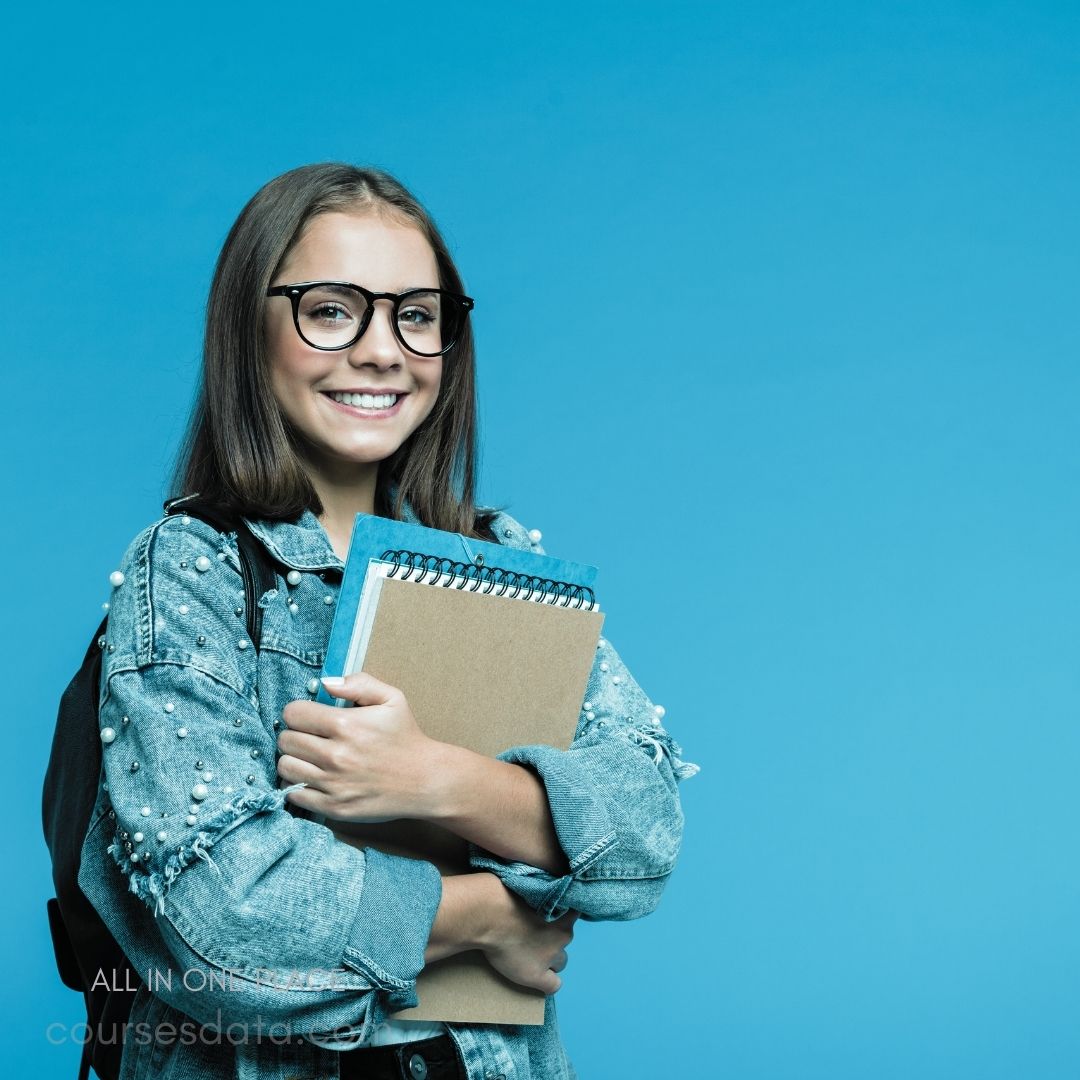 Smiling girl with school supplies.