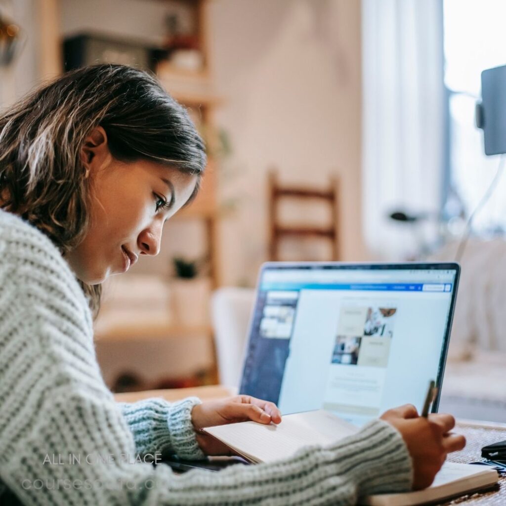 Young woman studying at laptop.