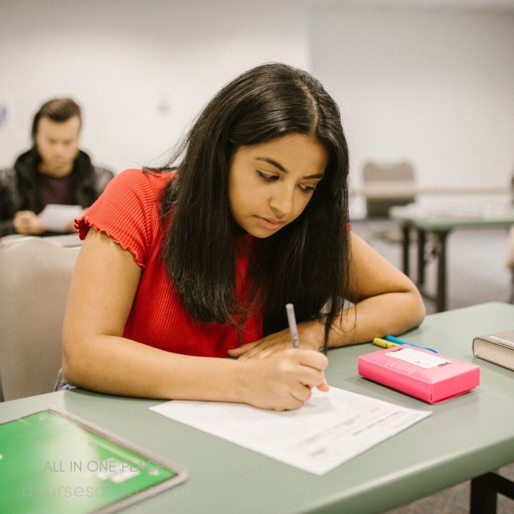 Student focused on exam paper.