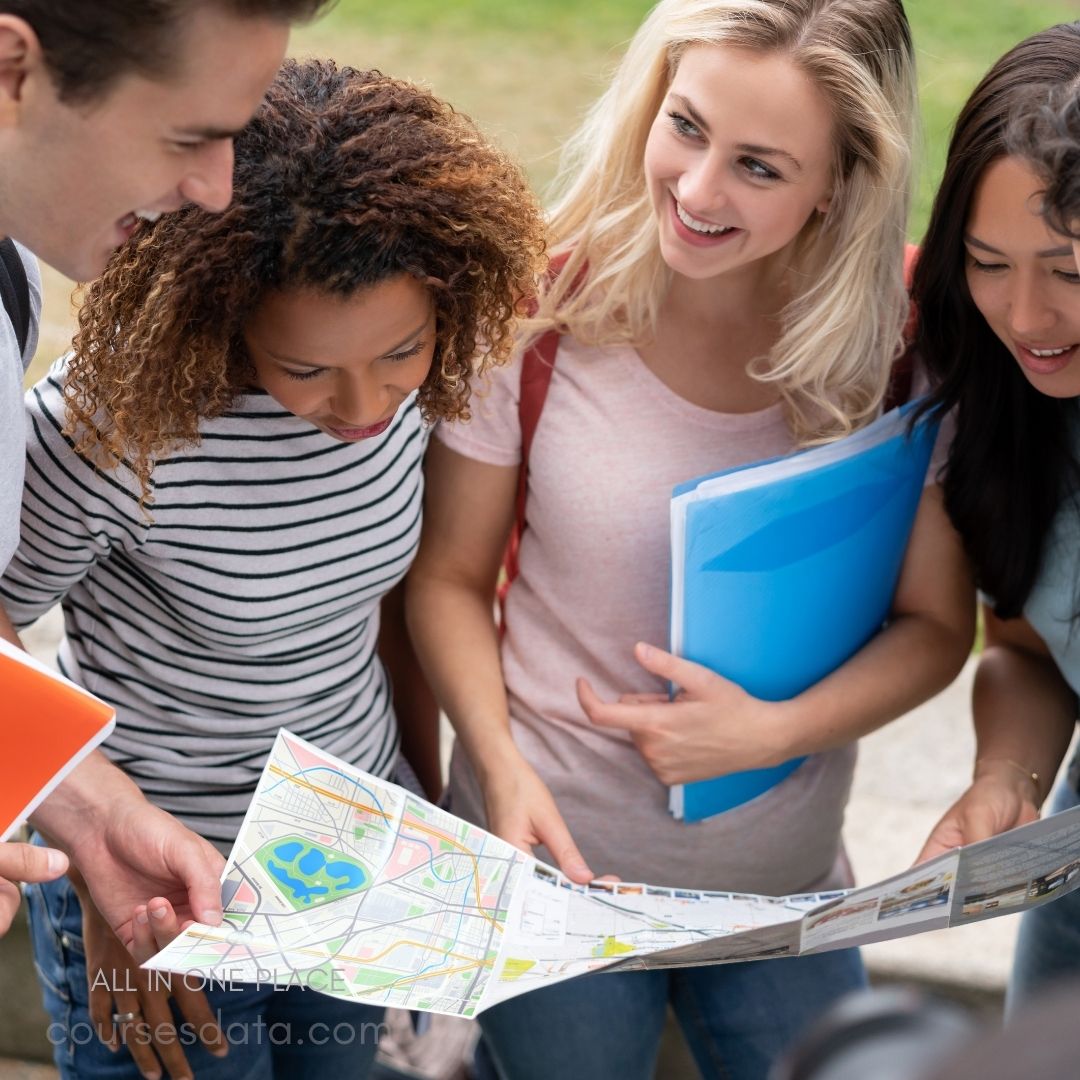 Group studying map together outdoors.
