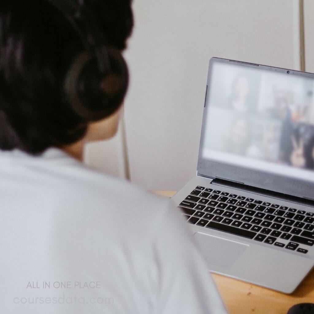 Person on video call, laptop screen.