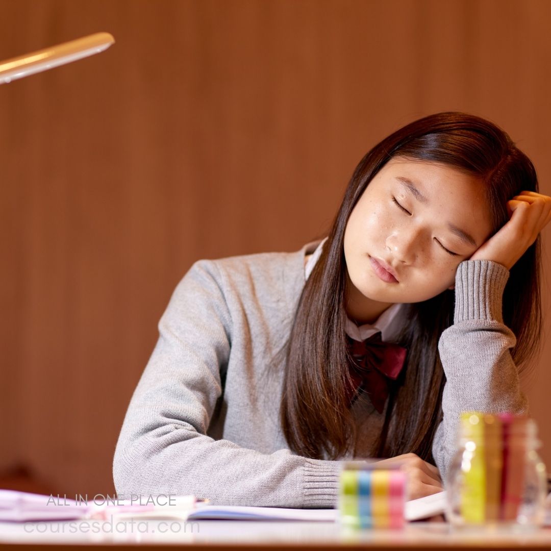 Student resting head on hand.