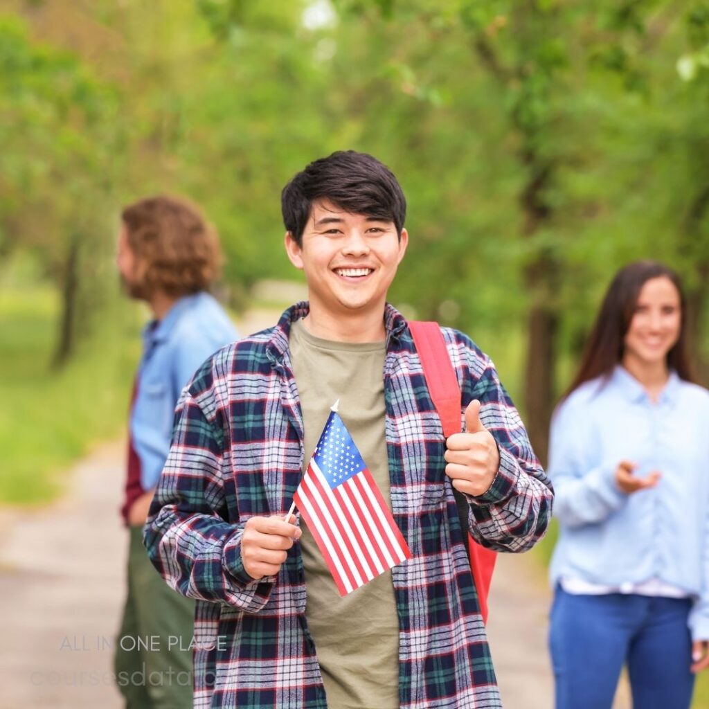 Smiling man holding American flag.