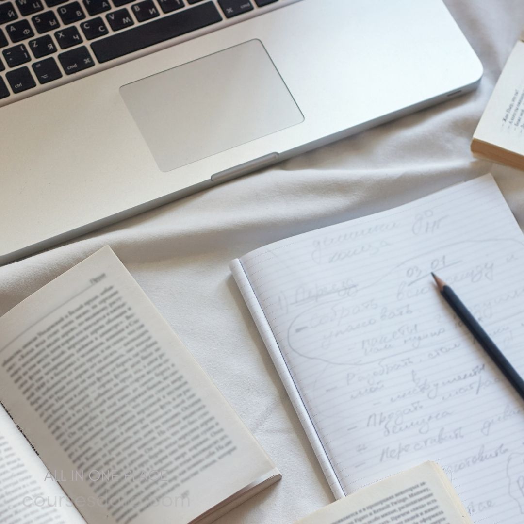 Laptop and notebooks on table.
