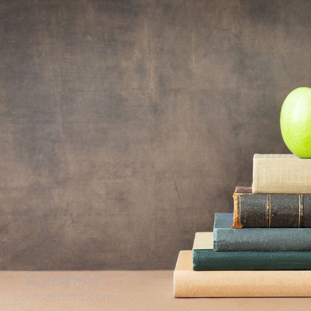 Stack of books with apple.