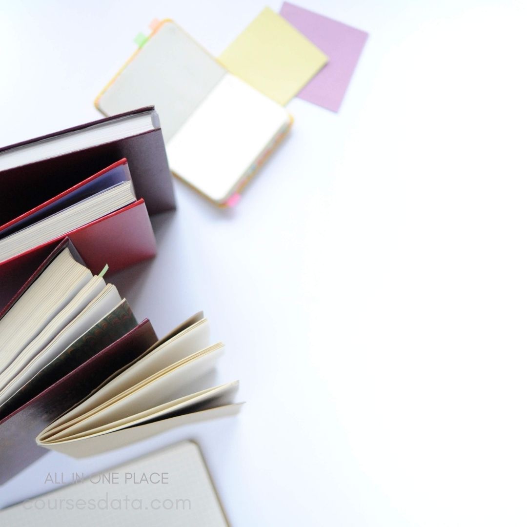 Open notebooks and colored papers.