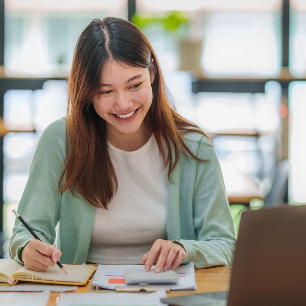 Smiling woman studying at desk.