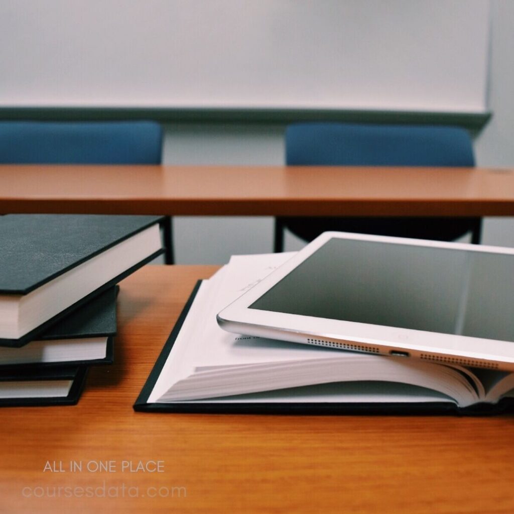 Books and tablet on desk.