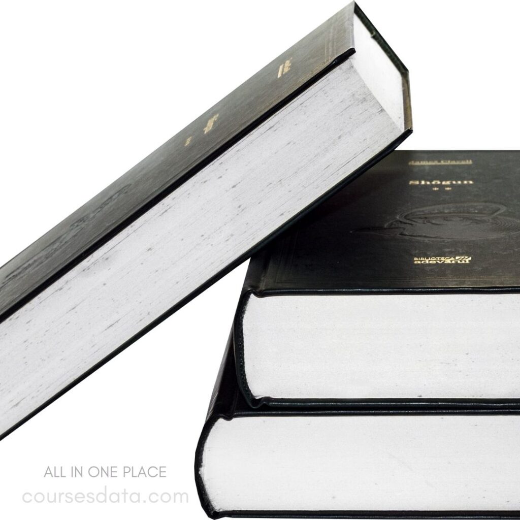 Three stacked books, black covers.