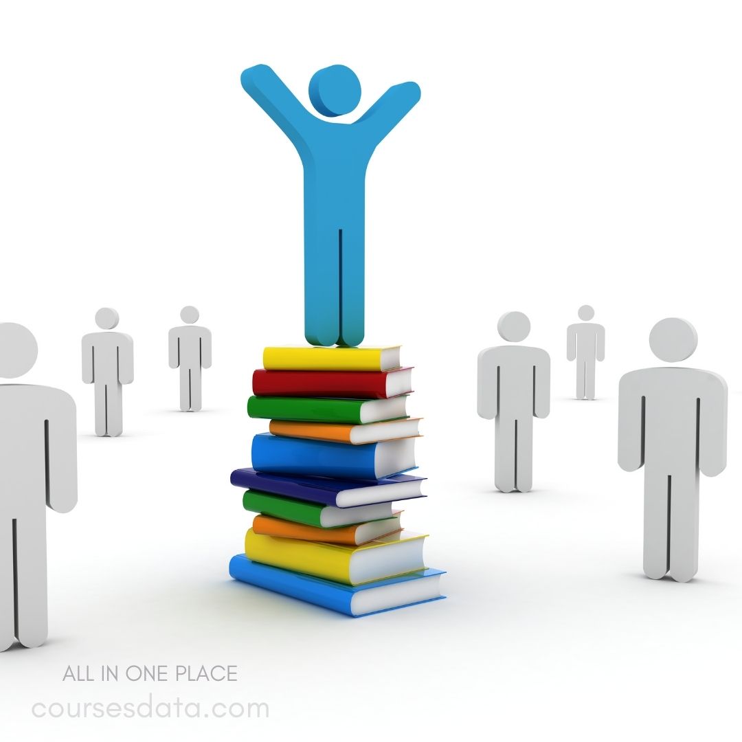 Person celebrating atop book stack.