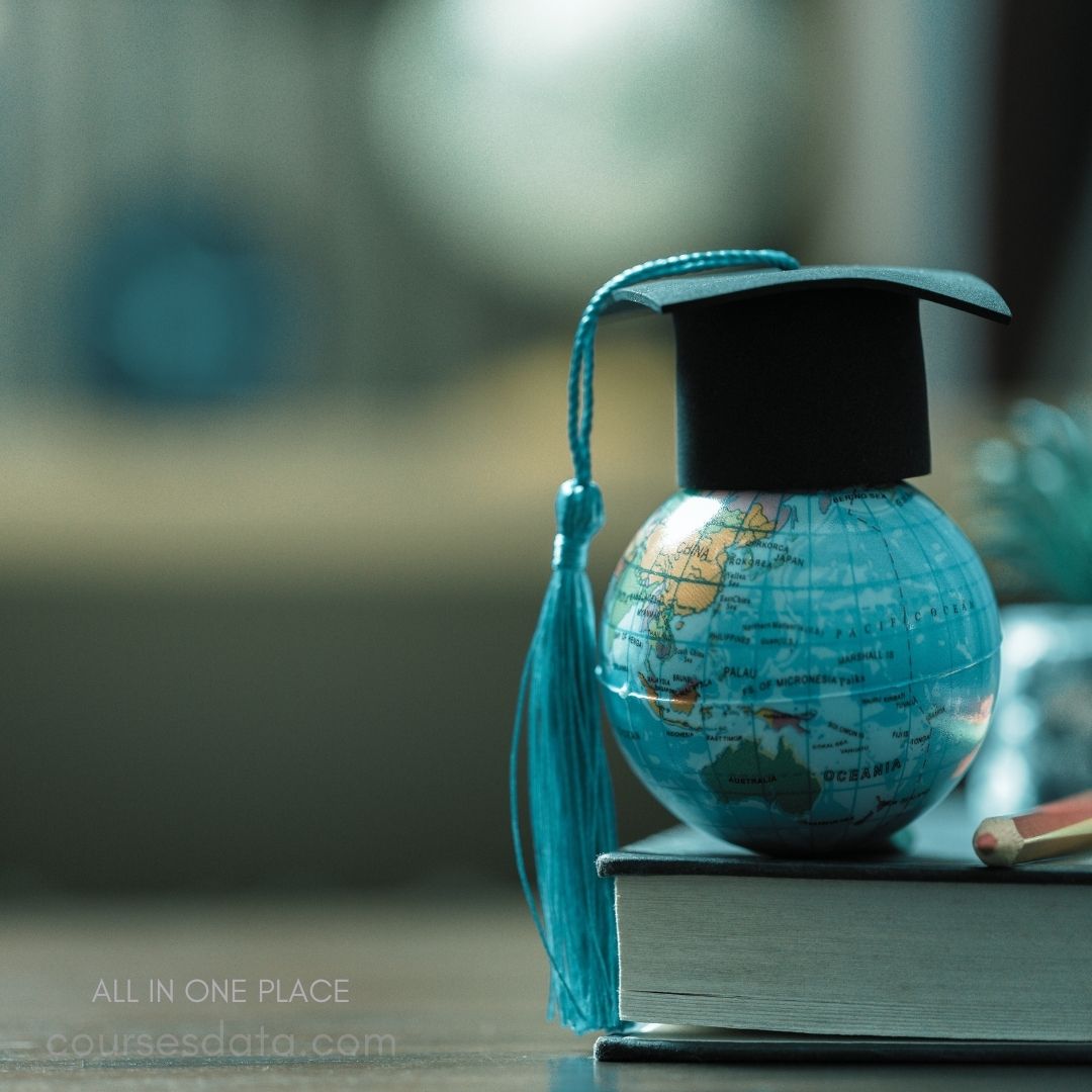 Graduation cap on globe figurine.
