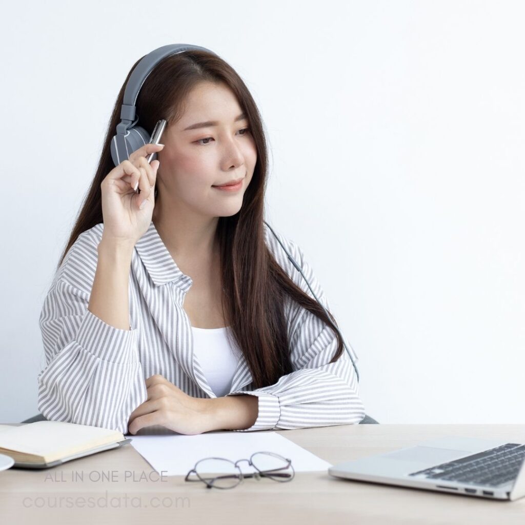 Woman with headphones in workspace.