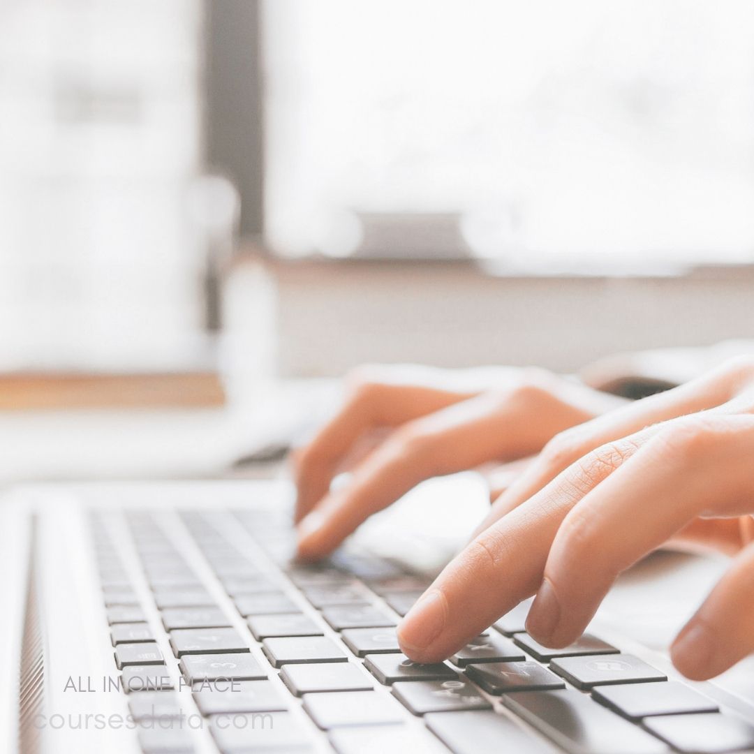 Hands typing on a keyboard.