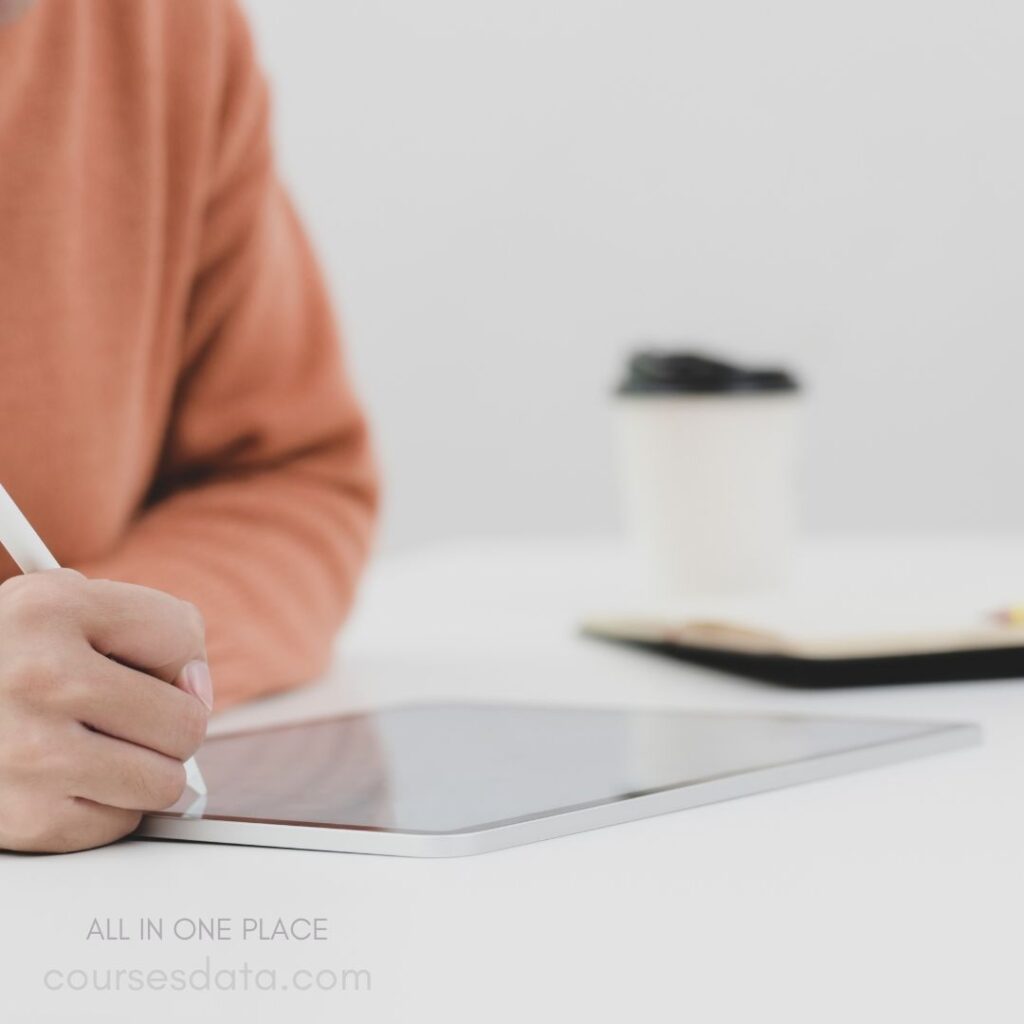 Person writing on tablet.