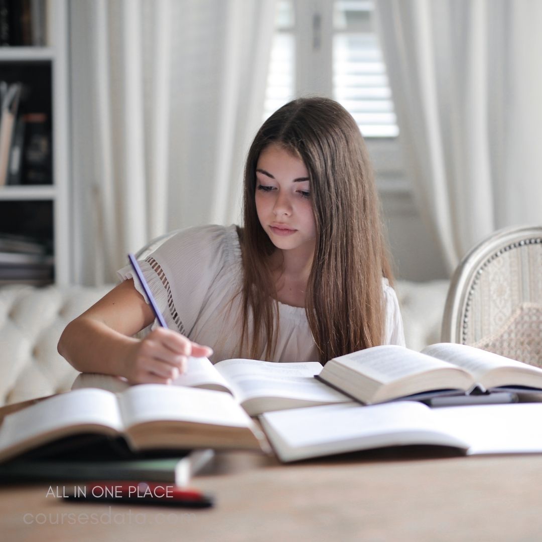 Girl studying with open books.
