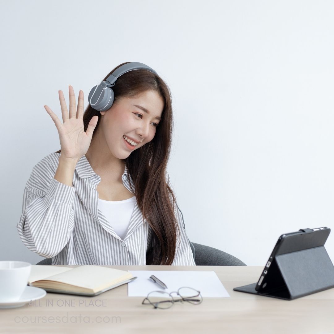 Smiling woman wearing headphones, video call.