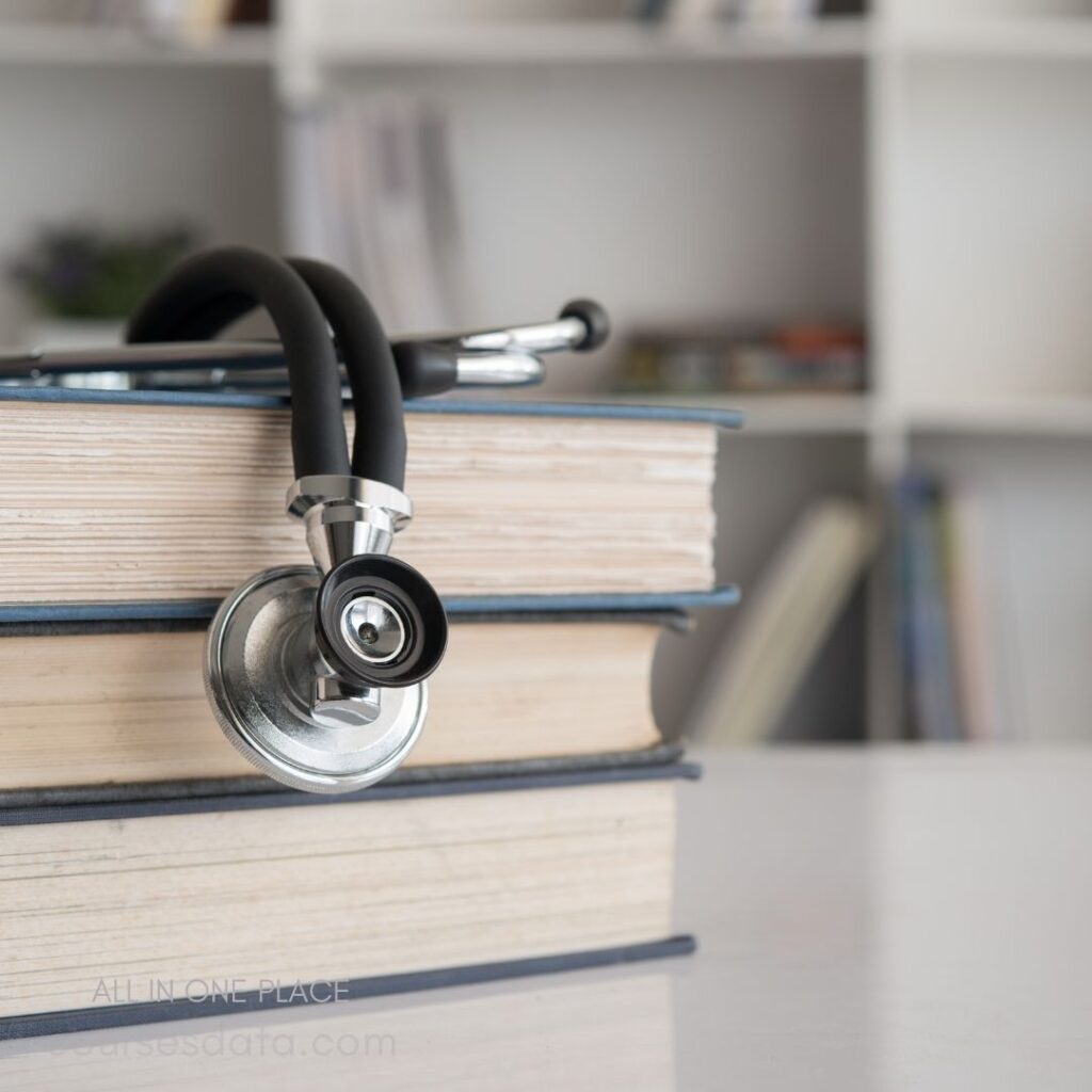 Stethoscope resting on stacked books.