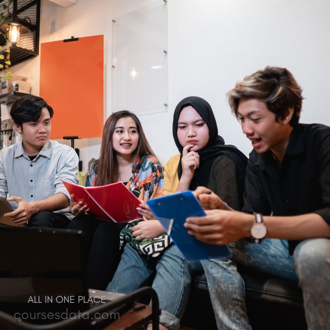Group discussion with notebooks.