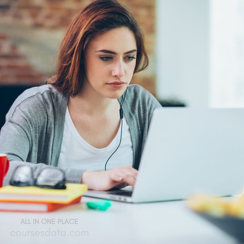 Focused woman using laptop.