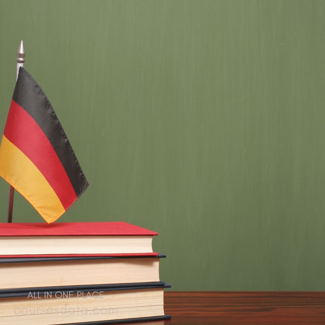 German flag beside stacked books.