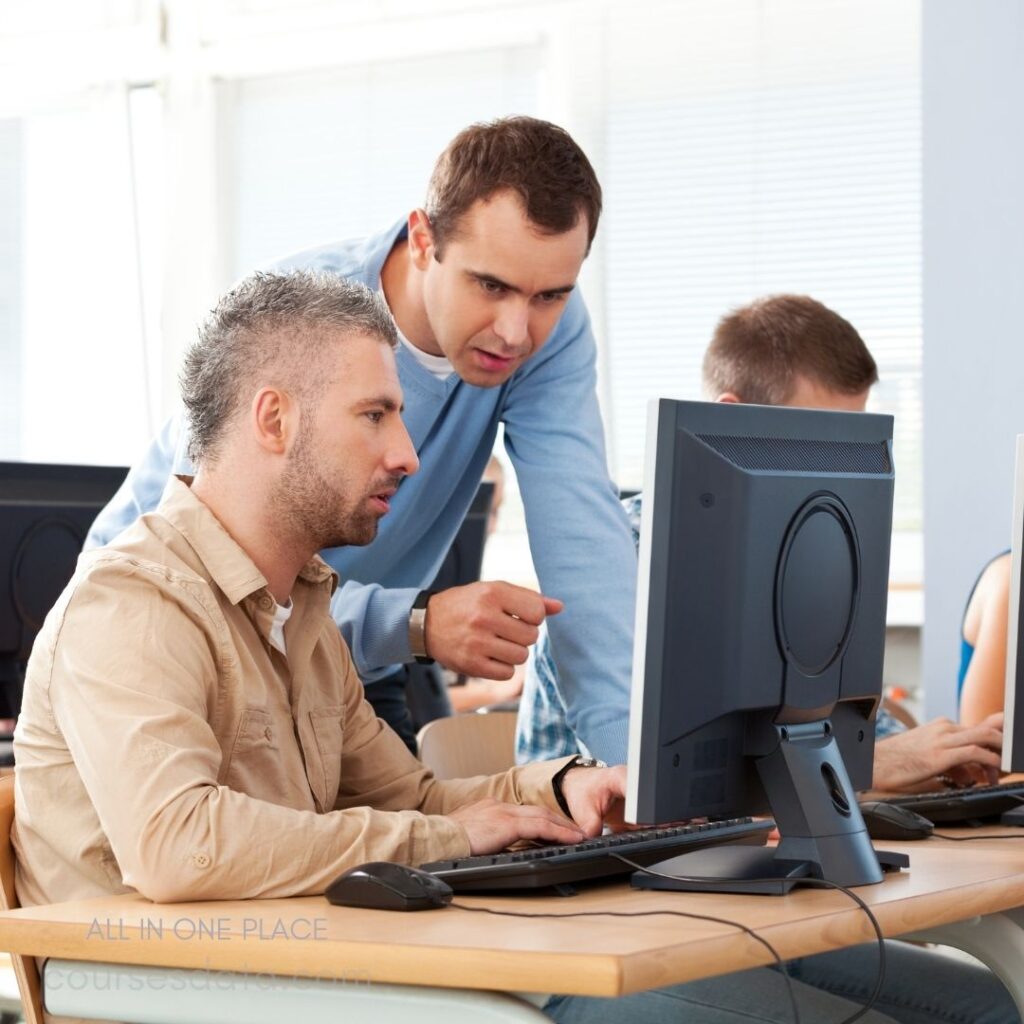 Two men collaborating at computer.