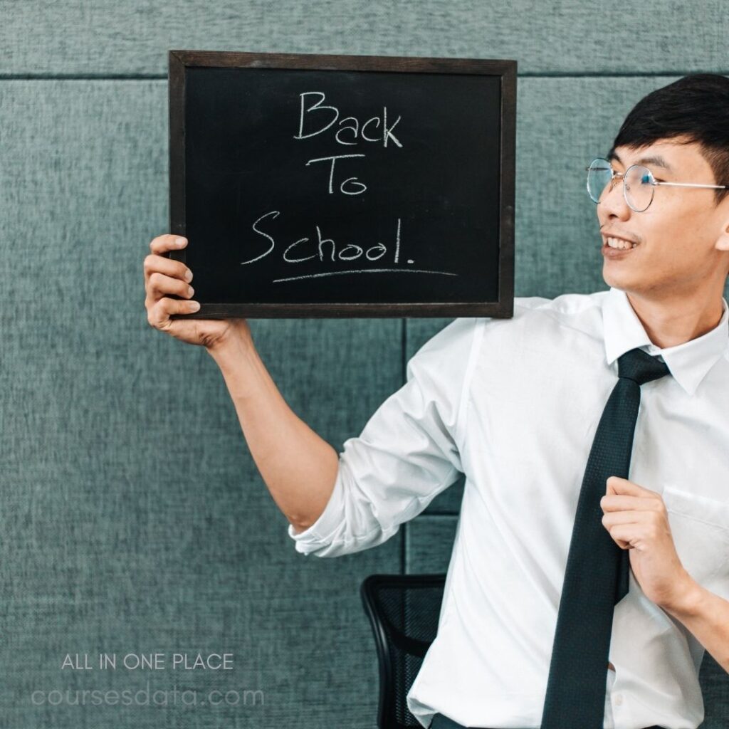 Man holding "Back to School" sign.