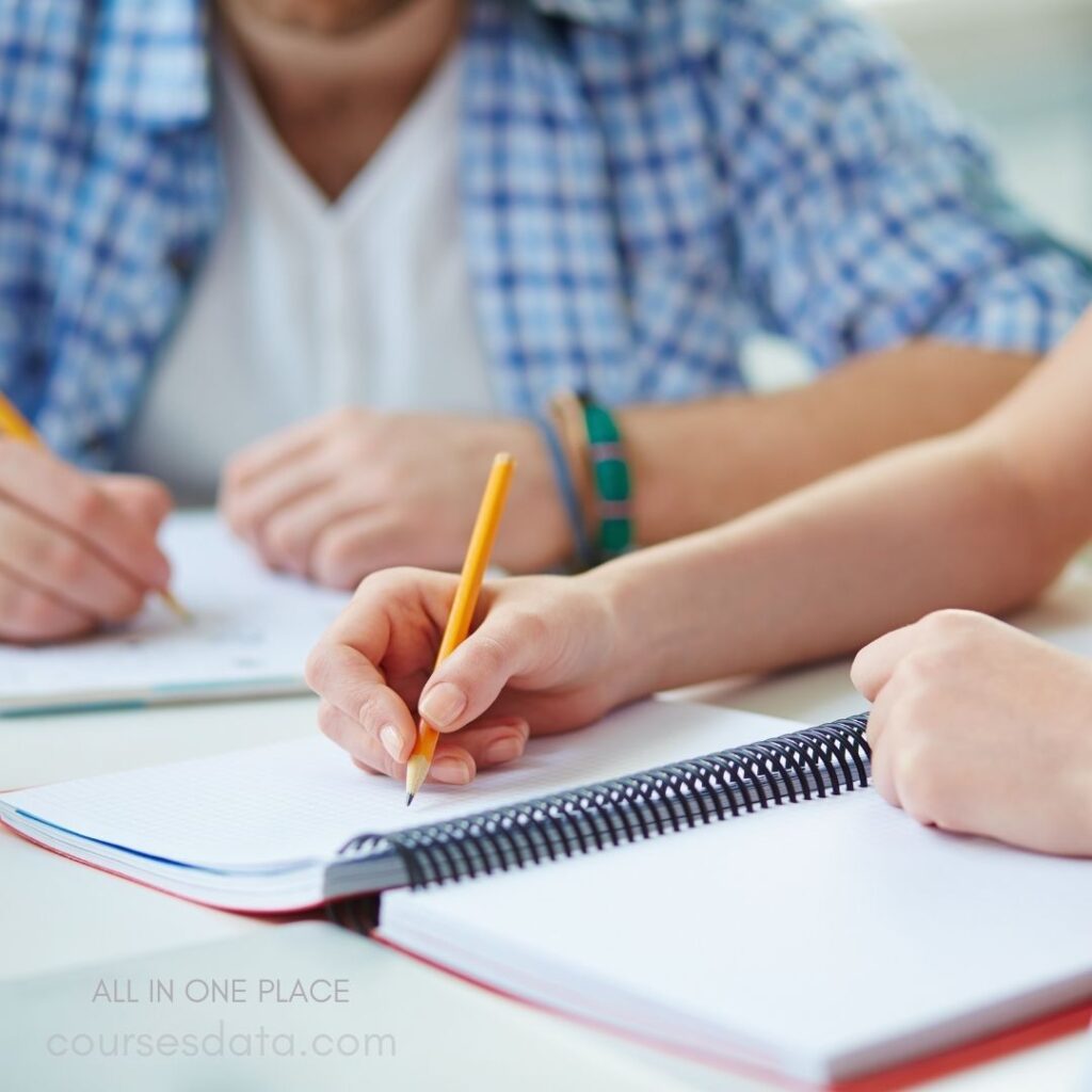 Students writing in notebooks.