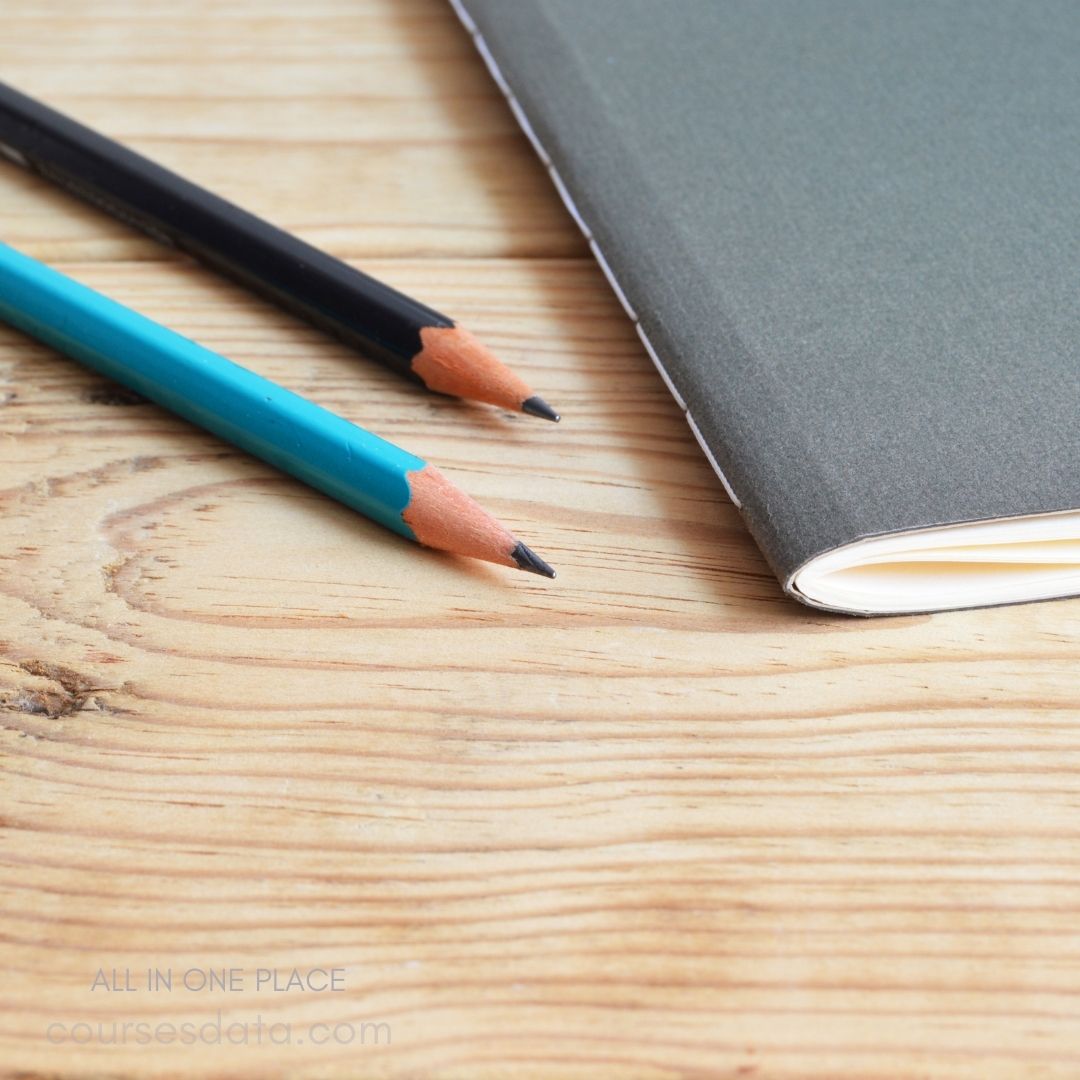 Colored pencils beside notebook.