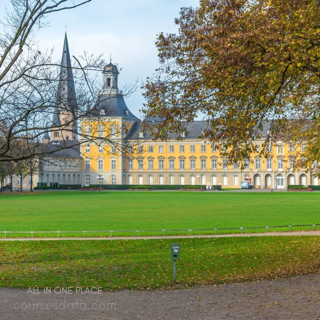 Historic yellow building, green lawn.